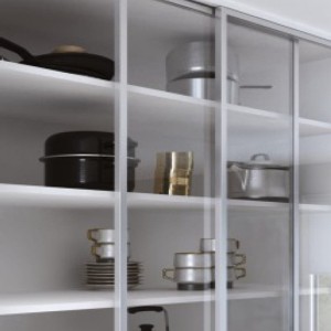 Shelving unit with ZOBAL sliding glass doors holding kitchenware